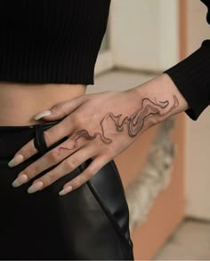 a woman's hand with a tattoo on it