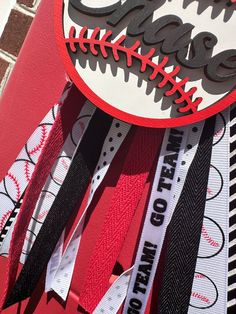 a close up of a baseball and ribbon decoration