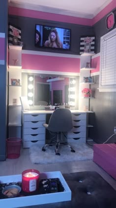 a pink and gray bedroom with lights on the dressers, television in the corner