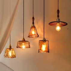 five lights hanging from a ceiling in a room