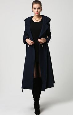 "This beautiful long wool coat features a double-breasted bodice and oversized silver buttons to create a distinct but classic military style. this winter coat features gorgeous navy blue wool, a polyester lining, and fun features like extra long sleeves, deep side pockets and back split vents. The self-tie belt makes it easy to accentuate your waist while the warm hood will stylishly shield you from the cold. DETAIL * 50% WOOL,50% POLYESTER * POLYESTER LINING * Epaulette with button * with warm Winter Office Peacoat With Buttons, Spring Long Peacoat With Buttons, Spring Peacoat With Buttons, Double-breasted Peacoat For Office In Winter, Double-breasted Winter Office Peacoat, Elegant Double-breasted Spring Peacoat, Elegant Spring Peacoat With Buttons, Double-breasted Wool Coat With Buttons For Winter, Double-breasted Winter Peacoat With Buttons