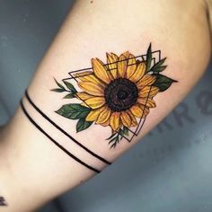 a sunflower tattoo on the left arm