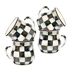 two checkered coffee cups and saucers on a white background