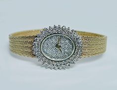 "This is a fabulous ladies vintage pre-owned watch and is made in ITALY!! The entire watch is crafted in 14K yellow gold, the case and the band. There are 90 fiery round cut diamonds set on the dial and around the bezel. The diamonds are estimated to be very clean VS-2-SI-1 in clarity and HI in color (near colorless). Grand total diamond weight is 2 full carats. Very HIGH QUALITY diamonds!! Incredible fire!! Sapphire crystal, Swiss made, quartz movement. The watch is 6-5/8\" (at the longest) wit Oval Diamond Watch For Anniversary, Yellow Gold Jewelry For Wedding, Yellow Gold Diamond Watch With 17 Jewels For Wedding, Yellow Gold Round Jewelry And Watches With Diamond Accents, Oval Diamond Watch For Formal Occasions, Yellow Gold Jewelry And Watches With Diamond Accents, Formal Oval Diamond Watch, Gold Diamond Watch For Evening, Yellow Gold Jewelry With Diamond Accents