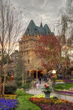 a large building with lots of flowers around it