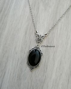 Necklace  with black onyx stone. The black onyx is a protective stone, it protects from the evil eye, it repels the presence of spirits who would try to influence you, it is very useful for mediums. It promotes a sense of responsibility and helps maintain self-control by being more poised. Dimensions: Chain: 48 centimeters Pendant: 4.3 centimeters high and 2.5 centimeters wide The length can be adjusted on request at the time of purchase, at no additional cost. Materials used: stainless steel ch Gothic Necklaces, Black Stone Necklace, Black Goth, Gothic Necklace, Black Onyx Stone, Black Chain, Onyx Stone, Black Stone, Star Necklace