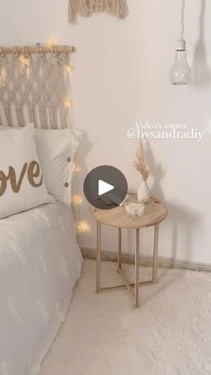 a bedroom with white bedding and string lights on the headboard is featured in this video