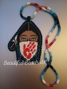 a beaded necklace with an image of a woman's face on it