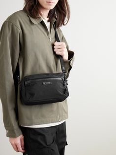 So much thought goes into the materials that make Master-Piece's bags – the front pocket of this 'Root S' messenger, for example, has a water-repellent AquaGuard® zip. Made from hard-wearing nylon with leather trims, it has an adjustable shoulder strap and is sized to hold your phone, keys and wallet. Nylon Shoulder Bag With Removable Pouch For Commuting, Modern Nylon Shoulder Bag With Multiple Pockets, Nylon Shoulder Bag For Everyday Use, Everyday Nylon Shoulder Bag With Removable Pouch, Nylon Shoulder Bag With Removable Pouch For Everyday, Commuting Crossbody Shoulder Bag With Pockets, Modern Shoulder Bag With Functional Pockets For Everyday, Everyday Shoulder Bag With Pockets, Everyday Carry Nylon Shoulder Bag With Zipper Pocket