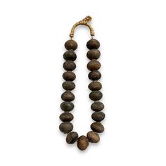 a wooden beaded necklace on a white background