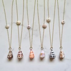 Long Cone Shell Necklaces~ Gorgeous big cone shells on 14k gold fill chain connecting with a puka shell. *Choose shell from the drop down menu. Each necklace varies in length ~ Shell #1 28" Shell #2 30" Shell #3 30" Shell #4 27" Shell #5 30" Shell #6 29" **Model wearing similar designs Shop~ http://www.etsy.com/shop/HanaMauiCreations?ref=pr_shop_more International buyers please read our shipping policies before ordering~ POLICIES~ https://www.etsy.com/shop/HanaMauiCreations/policy?ref=shopinfo_p Real Shell Jewelry, Limpet Shell Jewelry, Cone Shell Jewelry, Puka Shell Jewelry, Broken Shell Jewelry, Opihi Shell Jewelry, Small Shell Crafts, Surfer Girl Fashion, Shell Necklace Diy