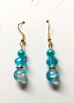 Caribbean blue dangle drops On gold plated hypoallergenic earring hooks Gold Beaded Dangle Earrings With French Hook, Turquoise Pearl Dangle Earrings, French Hook Beaded Drop Earrings, Blue Dangle Hoop Earrings Hypoallergenic, Blue Dangle Clip-on Earrings For Gift, Elegant Beaded Drop Earrings With French Hook, Light Blue Dangle Earrings For Pierced Ears, Blue Linear Earrings With Ear Wire For Gift, Blue Hypoallergenic Drop Earrings