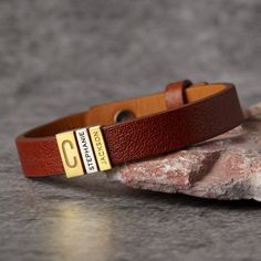 "This leather bracelet is engraved with Dad's initial on the bigger charm and kids' names on the smaller charms. Available in sterling silver with 18K gold plate options, this is the perfect gift for Dad on Father's day, at Christmas or a special day. You can select the number of kids' charms. P R O D U C T ∙ I N F O * Word limit: 9 letters/ a small charm * Materials: Genuine leather with sterling silver charms. * Finishing: Silver, Gold * Dimensions: Leather width measures .approx 3/8\"\" (11mm Personalized Rectangular Bracelets For Father's Day, Customizable Name Bracelet For Father's Day, Personalized Stainless Steel Name Bracelet For Father's Day, Personalized Engraved Nameplate Charm Bracelet, Engraved Brown Jewelry For Friendship, Father's Day Personalized Stainless Steel Name Bracelet, Brown Engraved Jewelry For Friendship, Engraved Brown Jewelry As Gift, Personalized Classic Bracelets For Father's Day