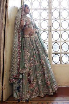 Sage green silk 24 kali lehenga with abstract floral pattern thread work and zari embroidery. Paired with an embroidered padded choli and dupatta.
Components: 3
Pattern: Embroidered
Type Of Work: Thread, Zari
Neckline: V Neck
Sleeve Type: Cap
Fabric: Lehenga and Choli: Silk, Dupatta: Organza
Color: Green
Other Details: 
Lehenga length: 43 inches
Occasion: Wedding, Mehendi and Haldi - Aza Fashions Transitional Green Lehenga With Resham Embroidery, Green Lehenga With Resham Embroidery For Transitional Season, Designer Green Lehenga For Transitional Season, Transitional Green Lehenga With Dupatta, Green Traditional Wear For Reception With Meenakari, Reception Green Traditional Wear With Meenakari, Green Floor-length Lehenga For Transitional Season, Pista Green Traditional Drape Sets With Meenakari, Pista Green Meenakari Sets Traditional Drape