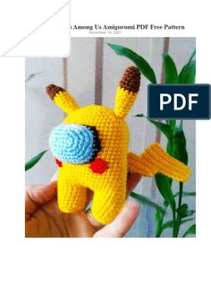 a crocheted pikachu doll in the palm of someone's hand