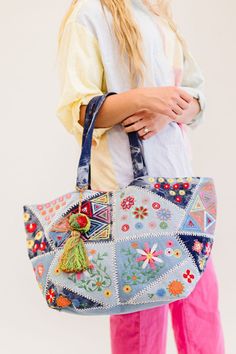 This one goes out to all our boho babes! The Arden is a colorful oversized tote that's sure to brighten up your day. This handmade piece features so many unique details, from the patchwork and tie-dye denim design to the bright fuchsia interior (no more digging in the endless abyss to find your keys). The Arden pairs well with all of your favorite summer activities: farmer's markets, getaways, beach time, and more! Details: 20” long x 14" height x 11” wide 3 interior pockets Patchwork denim deta Bohemian Rectangular Bag For Spring, Bohemian Spring Tote Bag, Beach Patchwork Tote Bag, Beach Tote Bag With Patchwork, Bohemian Bags For Everyday Use In Spring, Bohemian Bags For Everyday Spring, Bohemian Everyday Bags For Spring, Multicolor Embroidered Bags For Everyday Spring Use, Denim Tote Bag For Summer