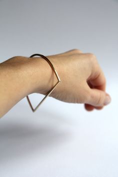 Minimalist geometric style D form bangle brass bracelet. Made from 2x2mm square profile brass wire with satin matt surface. 100% handmade. Also available in sterling silver. NB! Brass might eventually oxidise while wearing. Unsure of your size? There are two options how to measure the right size: - measure the inside diameter of a bangle / bracelet you already have. - loosely close your fist and measure from the center of the first knuckle to the center of the last knuckle. That size is equal to Stack Bangles, Geometric Bangle, Bangle Bracelet Gold, Geometric Bracelet, The Bangles, Circle Bracelet, Wire Bangles, Geometric Star, Brass Bracelet