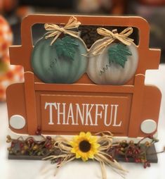 two pumpkins are sitting in the back of a truck that says, thank you