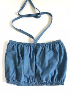 "These are handmade and reworked from old denim made into the perfect bubble tube tops that can be worn as halters or have the straps tucked in and worn as tubes. They best fit a small/ medium and fit from 24\"-30\" and are shown on a size medium model. The perfect summer wardrobe essential to pair with vintage Levis and prairie skirts. This listing is for one reworked bubble tube ✨(15)" Denim Blue Crop Top, Summer Denim Stretch Tube Top, Stretch Denim Tube Top For Summer, Summer Stretch Denim Tube Top, Summer Stretch Cotton Denim Vest, Spring Cotton Denim Crop Top, Stretch Cotton Denim Vest For Summer, Spring Stretch Denim Tube Top, Denim Blue Denim Tube Top