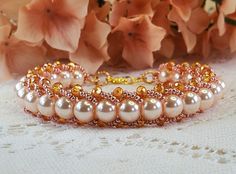 Beautiful hand beaded bracelet is made with light rose pearls, pink miyuki beads, as well as gorgeous bicone crystals giving it an elegant touch. This bracelet is simply stunning with its fabulous rose gold colors, and is sure to make a statement. A lovely gift for all the special people in your life, including yourself! Measurements = Length: 8.25 - 8.50 inches Width: 11/16 of an inch  Fits nicely on 7 to 8.5 inch wrist. Rose Gold Pearl Beaded Bracelets, Handmade Rose Gold Bracelets With Round Beads, Elegant Pink Beaded Bracelets With Gold Beads, Handmade Rose Gold Bracelet With Round Beads, Rose Gold Beaded Pearl Bracelets, Adjustable Rose Gold Pearl Beaded Bracelets, Handmade Rose Gold Beaded Bracelet With Round Beads, Handmade Rose Gold Beaded Bracelets, Handmade Rose Gold Crystal Bracelet With Round Beads