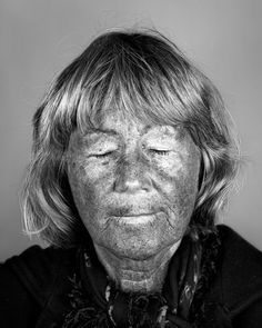 an old woman with wrinkles on her face and eyes, looking at the camera