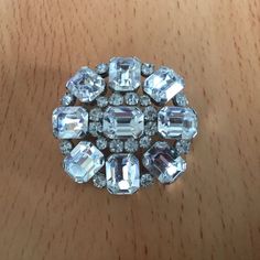 Vintage Emerald Cut Clear Rhinestone Brooch on Silver Tone Setting. This stunning pin will make a beautiful gift. Measures 1 4/8 inches in diameter. Has a rollover safety clasp. Very good condition. Please see photos. 2022-04 Round Rhinestone Brooches For Formal Occasions, Round Crystal Brooch For Party, Crystal Round Brooch For Party, Formal Crystal Brooches With Rhinestones, Round Formal Brooches With Rhinestones, Formal Round Brooches With Rhinestones, Wedding Brooches With Rhinestones, Anniversary Round Brooches With Rhinestones, Formal Crystal Rhinestone Brooches