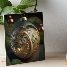 a christmas ornament sitting on top of a table next to a potted plant