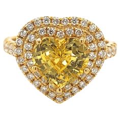 Elegant heart shape yellow sapphire ring. Hi brilliance, transparent clean, golden yellow tone, heart shape, unheated yellow sapphire mounted in high profile with five bead prongs, accented with two rows of round brilliant cut diamonds. Handcrafted heart shape classic design set in 14 karats yellow gold. Ideal for weddings and engagements! Yellow Sapphire: 3.19 carats, unheated, hi brilliance, golden yellow tone Diamond: 0.70 carat, round brilliant cut Color: G-H Clarity: Dimensions: 14mm x 14mm