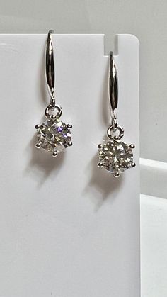 Silver with 14K White Gold Rhodium Brilliant Cut Moissanite Hanging Solitaire Earrings Dangling. 1 Carat Each Moissanites Set in a Solitaire Style with Six Prongs. Moissanite weighs approximately 2.00 Carats in total. 7mm in diameter.   Beautiful clarity and color, amazing brilliance.   Moissanites are alternatives to mined diamonds for those interested in a stones other than diamonds. Certified Moissanite, paperwork included in sale. Hanging Earring, Diamond Solitaire Earrings, Diamond Pendants Designs, Earrings Dangling, Solitaire Earrings, Garnet Earrings, Hanging Earrings, Solitaire Pendant, Dangling Earrings