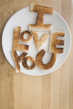 the word i love you spelled with toasted bread on top of a white plate