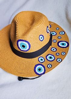 Beach hat, women's hat, with 100% hand-painted Turkish eye design. For all occasions Handmade Artisan Fedora For The Beach, Handmade Artisan Fedora For Beach, Hand Painted Wide Brim Hats For The Beach, Hand Painted Wide Brim Hat For Beach, Hand Painted Wide Brim Beach Hat, Beach Hats With Hand Painted Adjustable Design, Beach Hats With Hand Painted Adjustable Fit, Beach Hats With Hand Painted Short Brim, Bohemian Hand Painted Hats For Vacation