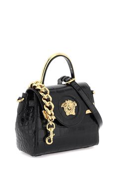 La Medusa handbag by Versace crafted in croco-embossed leather, featuring flap with magnetic button closure and the iconic metal Medusa head. Single handle with gold metal detail, removable chain shoulder strap and removable and adjustable crossbody shoulder strap in leather. Side straps, leather interior with an open flat pocket. Versace Gold finished metalware. Size Info STANDARD Color Detail Black Made In Italia Material 100% calf leather Season One spring Season Two summer Product bags Brand Designer Top Handle Shoulder Bag With Gold-tone Logo, Designer Top Handle Bag With Gold-tone Logo Plaque, Evening Shoulder Bag With Gold-tone Logo And Double Handle, Luxury Crossbody Bag With Gold-tone Logo Plaque, Luxury Double Handle Shoulder Bag With Gold-tone Logo Plaque, Designer Top Handle Shoulder Bag With Metal Logo, Designer Shoulder Bag With Top Handle And Metal Logo, Luxury Crossbody Flap Bag With Gold-tone Logo, Evening Top Handle Bag With Gold-tone Logo