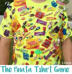 a young boy wearing a yellow t - shirt with candy buttons all over it and the words, the pinata thrift game