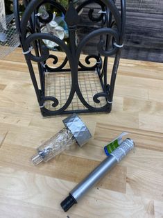 a pen is laying on the floor next to a candle holder