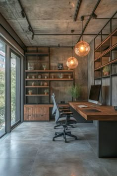 an office with concrete floors and lots of shelves on the wall, along with large windows