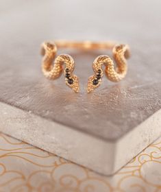 Fab and Sophisticated snake band in Bohemian Chic style. The snake texture inspired by mystical alchemical Ouroboros snake, which is one of the traditional infinity symbols. It has comfort fit and you won't want to take it off! About this item: -Flipped Black diamonds. 0.05 total carat weight --Solid 14K Rose/Yellow/White Gold OR -Solid 18K Rose/Yellow/White Gold PLEASE NOTICE: This price is for the ring's sizes up to 8, if you need a bigger size > contact us for price & details! Please a Unique Snake-shape Wedding Ring, Formal Adjustable Open Snake Ring, Luxury Adjustable Snake Ring, Luxury Adjustable Snake Ring For Gift, Luxury Adjustable Snake Ring Gift, Wedding Ring Black Diamond, Gothic Wedding Ring, Fiance Ring, Wedding Ring Black