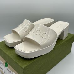 Gucci's 'Plastique' Mules Feel Like The Most Glamorous '90s Throwback. Made In Italy From Glossy Rubber Embossed With The House's Emblem, They Have Square Toes And Are Set On Gripped 30mm Block Heels. Slip Yours On With Everything From Skirt Suits To Denim Cut-Offs. Heel Measures Approximately 30mm/ 1 Inch White Rubber Slip On Includes Box But No Dust Bags Gucci Block Heel Summer Heels, Gucci Block Heels For Summer, Summer Gucci Block Heels, Gucci Luxury Summer Heels, Luxury Gucci Heels For Summer, Summer Luxury Gucci Heels, Gucci Designer Sandals With Block Heel, Gucci Summer Platform Heels, Summer Gucci Platform Heels