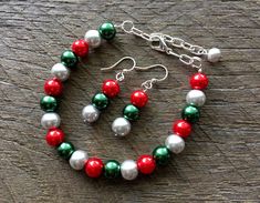 "Silver Red Green Christmas Set, Bracelet Earring Set, Pearl Bracelet, Pearl Earrings, Christmas Jewelry, Xmas Jewelry on Silver Chain with Lobster Claw Clasp and French Wire Hook Perfect for your classy Christmas party or pair with your ugly Christmas sweater! Bracelet Length: 6.25 to 8 inch wrist. If you need a different size, please include your wrist measurement in the \"note to seller\" section at checkout or feel free to contact me. Pearl Size: 8mm DISCOUNT: If you would like 5 or more of Red Round Beads Jewelry For Christmas, Red Christmas Party Bracelets, Red Jewelry For Holiday Jewelry Making, Red Jewelry For Christmas Holiday, Silver Christmas Festive Bracelets, Silver Bracelets For Christmas Festive Season, Festive Silver Bracelets For Christmas, Christmas Party Beaded Bracelets, Adjustable Christmas Jewelry For Holiday