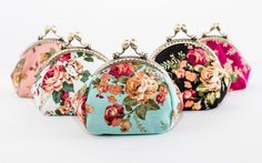 three purses with flowers on them sitting side by side in front of each other