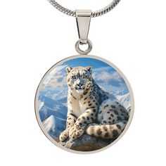 Celebrate the majesty of the mountains with this stunning pendant, featuring the elegant snow leopard in its snowy alpine habitat. Expertly crafted to highlight the beauty and strength of this magnificent creature, the piece captures the serene yet powerful presence of the snow leopard. Forged from premium surgical steel and available with a lavish 18k gold finish, this innovative jewelry boasts our exclusive design, handcrafted with care right here in the U.S.A by our dedicated team of skilled working mothers. When you choose our necklace, you not only acquire a stunning memento for yourself or a cherished one but also champion the empowerment of working mothers and vibrant communities. Rest assured, your satisfaction is paramount to us, backed by our 100% Happiness Guarantee, ensuring a Circle Pendant Necklace, Luxury Necklace, Working Mother, Snow Leopard, Working Moms, Circle Pendant, Necklace Silver, The Snow, Gold Finish