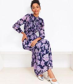 With a smocked top, puffed blouson sleeves, a flowy skirt, and ruffle trim, this dress is flattering, flirty, romantic - basically, it's a total wardrobe dream. Standing collar. Front Henley placket. 3/4 sleeves with button cuffs. Lined.,Fabric:Fabric: Fluid woven,Hit:Hit: Maxi - Hits at ankle,Imported:Imported,Fit:Fit: Waisted - fits and flatters waist,Length:54 1/4" from shoulder to hem, measured from a size 8/M,Fabrication:Shell: 100% Polyester Lining: 100% Polyester Exclusive of elastic,Garment Care:Machine Washable Loft Floral Clip Smocked Tiered Maxi Dress Size 10 Deep Space Blue Women's by Loft Size Regular - 10 Deep Space Blue Women's Fit,  Flare, Dresses, Everyday, Shell:, 100%, Polyester, Lining:, 100%, Polyester, Exclusive, of, elastic, Machine, Washable Flowy Spring Dress With Smocked Cuffs, Elegant Flowy Dresses With Smocked Cuffs, Chic Flowy Maxi Dress With Smocked Cuffs, Spring Date Night Smocked Dress With Ruffles, Feminine Flowy Smocked Dress With Smocked Cuffs, Flowy Feminine Smocked Dress With Smocked Cuffs, Flowy Daywear Dresses With Smocked Cuffs, Chic Tiered Dress With Smocked Cuffs, Flowy Dresses With Smocked Cuffs For Daywear