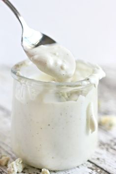 a spoon full of yogurt on top of a wooden table