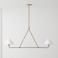 a light fixture with three lamps hanging from it's sides in a white room