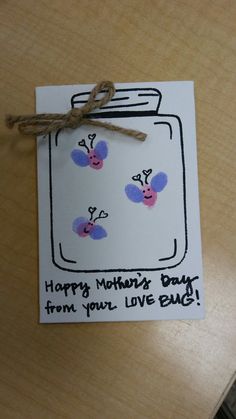 a happy mother's day card from your love bug on a wooden table top