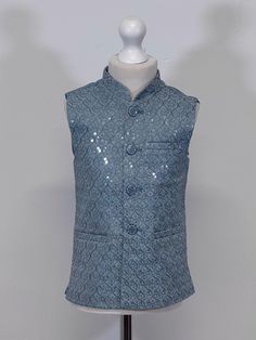 Introducing our exquisite Boys Jamawar Waistcoat, a luxurious addition to any gentleman's wardrobe. Handcrafted from the finest quality Jamawar fabric, this waistcoat is fully lined for added comfort. Featuring a timeless design, it comes with Gold buttons that add a touch of elegance to any outfit. The waistcoat also comes with pockets, providing ample storage space for your essentials. Perfect for formal occasions, this waistcoat is sure to make a statement and impress all those around you. Fitted Sleeveless Nehru Jacket For Winter, Festive Formal Fitted Vest, Sleeveless Nehru Jacket For Formal Festive Occasions, Festive Sleeveless Nehru Jacket For Formal Occasions, Fitted Sleeveless Outerwear For Festive Occasions, Elegant Sleeveless Festive Outerwear, Gentleman's Wardrobe, Light Teal, Mens Clothing