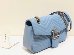 Description GG Marmont Small Matelassé Shoulder Bag Sky Blue Matelassé Chevron For Women 10in/26cm GG Rep 1:1 Measurements: 26 x 15 x 7 cm / 10″W x 6″H x 3″D (Length x Width x Height) The small GG Marmont camera bag has a softly structured shape and a flap closure with Double G hardware. The sliding chain strap can be worn multiple ways, changing between a shoulder and a top handle bag. Made in matelassé chevron with a heart on the back. Sky Blue matelassé chevron with a heart Antique gold-toned Gucci Marmont Camera Bag, Gg Marmont Small Matelassé Shoulder Bag, Gg Marmont Small Shoulder Bag, Gucci Marmont, Gg Marmont, Evening Clutch Bag, Small Shoulder Bag, Chanel Boy Bag, Tote Backpack