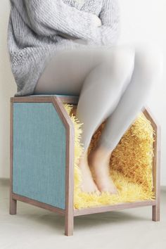 a woman sitting on top of a wooden structure with her legs up in the air