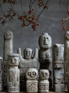 an assortment of stone statues sitting next to each other