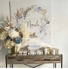 a table with flowers and candles on it in front of a sign that says noh