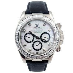 Men's Rolex Daytona 40mm Leather Band Watch with Mother of Pearl Diamond Dial and Diamond Bezel. Pre-Owned Year: 2005. Brand: Rolex. Gender: Men's. Bezel: Diamond. Type: Wristwatch. Case Size: 40mm. Condition: Excellent. Model Name: Daytona. Model Number: 116518. Band/Strap: Leather Band. Case Material: White Gold. Dial Color: Mother of Pearl. Hour Marks: Diamond Indexes. Water Resistance: 100m (10 ATM). Movement: Mechanical (Automatic). Certificate Detail: Rolex Card or Paper. Box / Certificate Men's Rolex, Rolex Men, Rolex Daytona, Leather Watch Bands, Pearl Diamond, Bezel Diamond, Paper Box, Leather Band, Rolex Watches